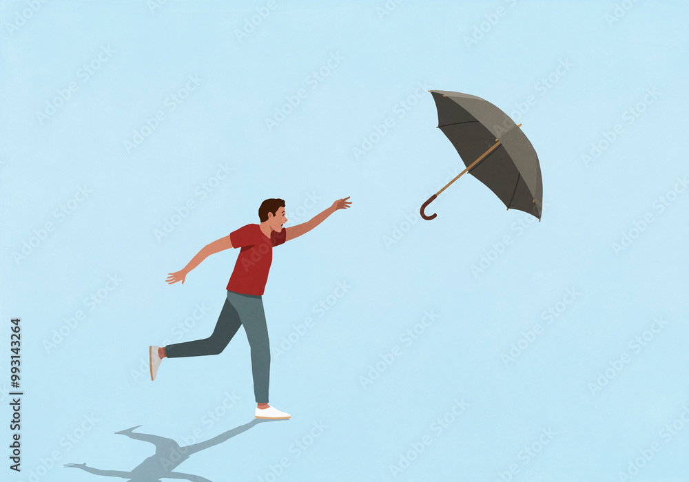 Man chasing umbrella flying in wind against blue background
Man chasing umbrella flying in wind against blue background