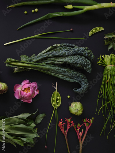 Flat lay still life green vegetables, pink peony and plant stems on black background
 photo