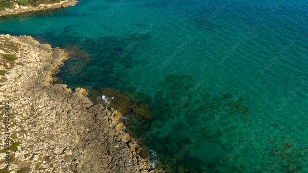 Aerial view of a rocky coastline in Puglia, Italy. The coast overlooks the Mediterranean Sea. Aerial view of a rocky coastline in Puglia, Italy. The coast overlooks the Mediterranean Sea.
