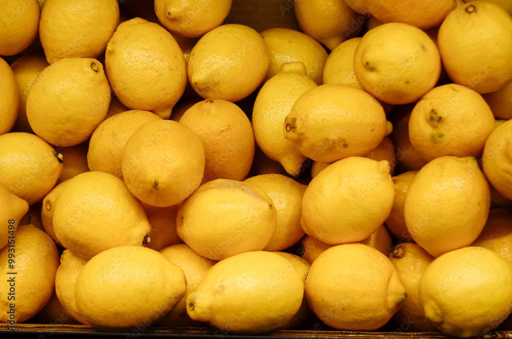 Many lemons in a box in a long overhead shot Many lemons in a box in a long overhead shot