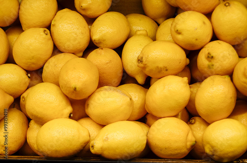 Many lemons in a box in a long overhead shot