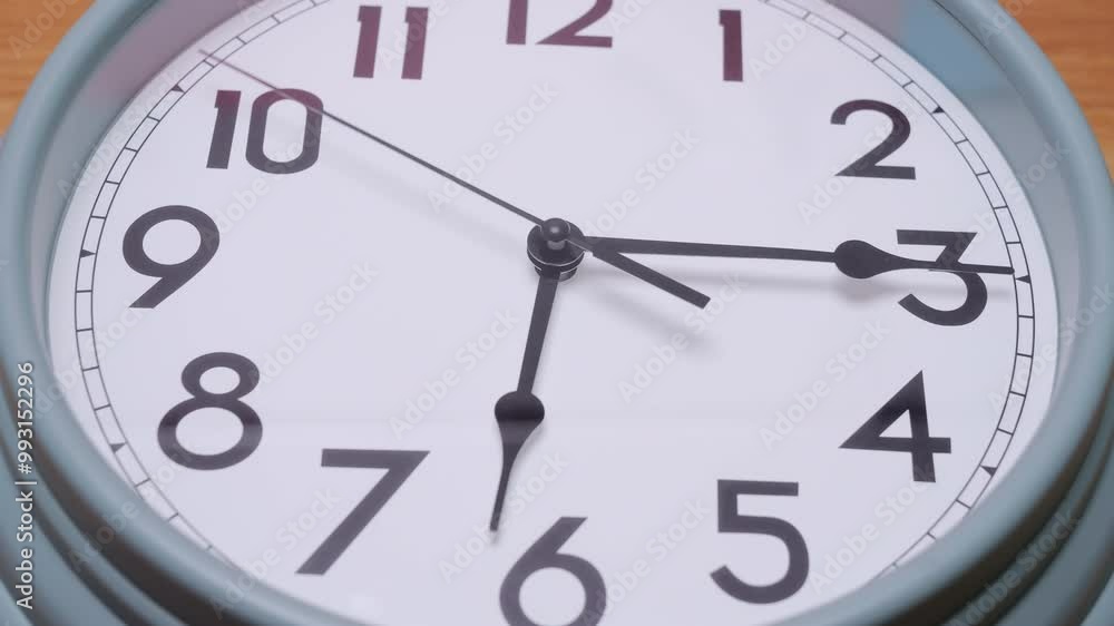 Time-lapse Close-up Top view white wall clock with black numbers tells the time 6:00 a.m. Time-lapse Close-up Top view white wall clock with black numbers tells the time 6:00 a.m.