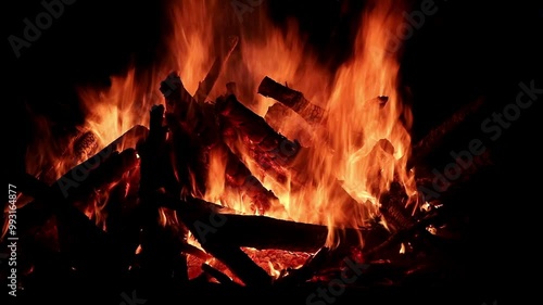 View loop of burning firewoods, bright firecamp with sparks at night, Camp fire in the night. Exploring the wildness travelling in outdoor photo