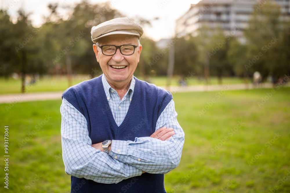Portrait of happy senior man in park on sunny day. Portrait of happy senior man in park on sunny day.