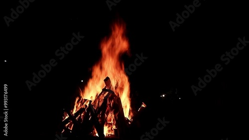 View loop of burning firewoods, bright firecamp with sparks at night, Camp fire in the night. Exploring the wildness travelling in outdoor photo