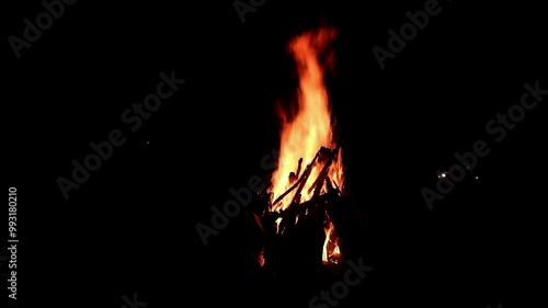 View loop of burning firewoods, bright firecamp with sparks at night, Camp fire in the night. Exploring the wildness travelling in outdoor photo