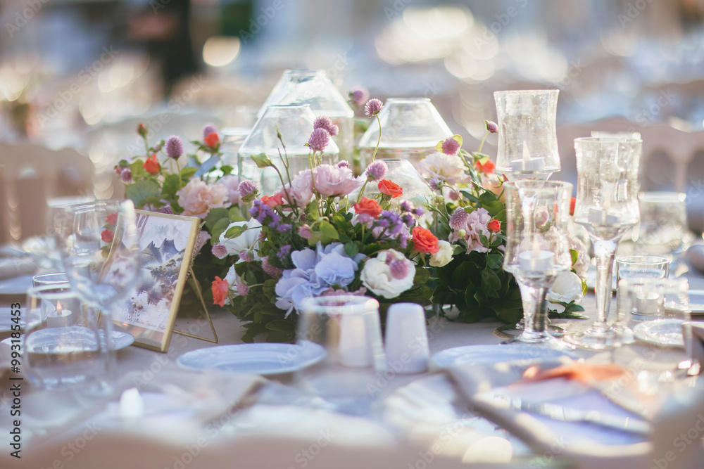 Elegant Waterfront Outdoor Wedding Reception with Draped Canopy, Floral Centerpieces, and White Chairs at a Luxurious Seaside Venue Elegant Waterfront Outdoor Wedding Reception with Draped Canopy, Floral Centerpieces, and White Chairs at a Luxurious Seaside Venue