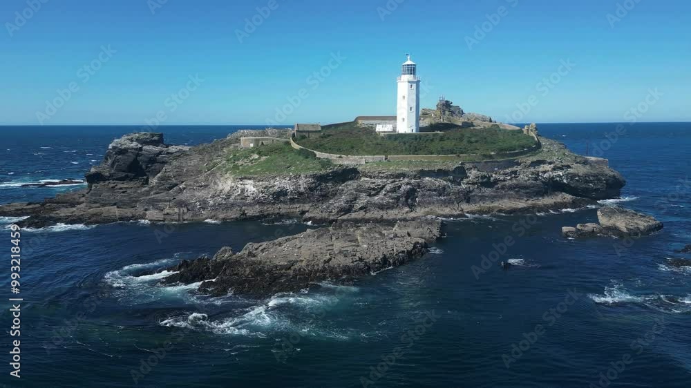 Godrevy Island, Cornwall, England: DRONE VIEWS: The island and Godrevy lighthouse. Godrevy lighthouse first began operating on 1st March 1859 and was built to warn of the nearby Stones Reef (Clip 12). Godrevy Island, Cornwall, England: DRONE VIEWS: The island and Godrevy lighthouse. Godrevy lighthouse first began operating on 1st March 1859 and was built to warn of the nearby Stones Reef (Clip 12).