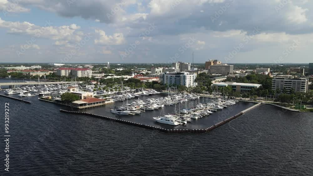 Aerial view of Bradenton marina with boats docked and the city skyline over the Manatee River. Crane Down Left Day Aerial view of Bradenton marina with boats docked and the city skyline over the Manatee River. Crane Down Left Day