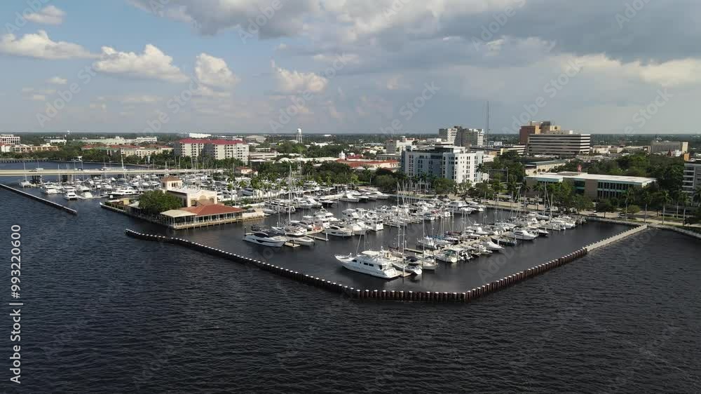 Aerial view of Bradenton marina with boats docked and the city skyline over the Manatee River. Orbit Right Day Aerial view of Bradenton marina with boats docked and the city skyline over the Manatee River. Orbit Right Day