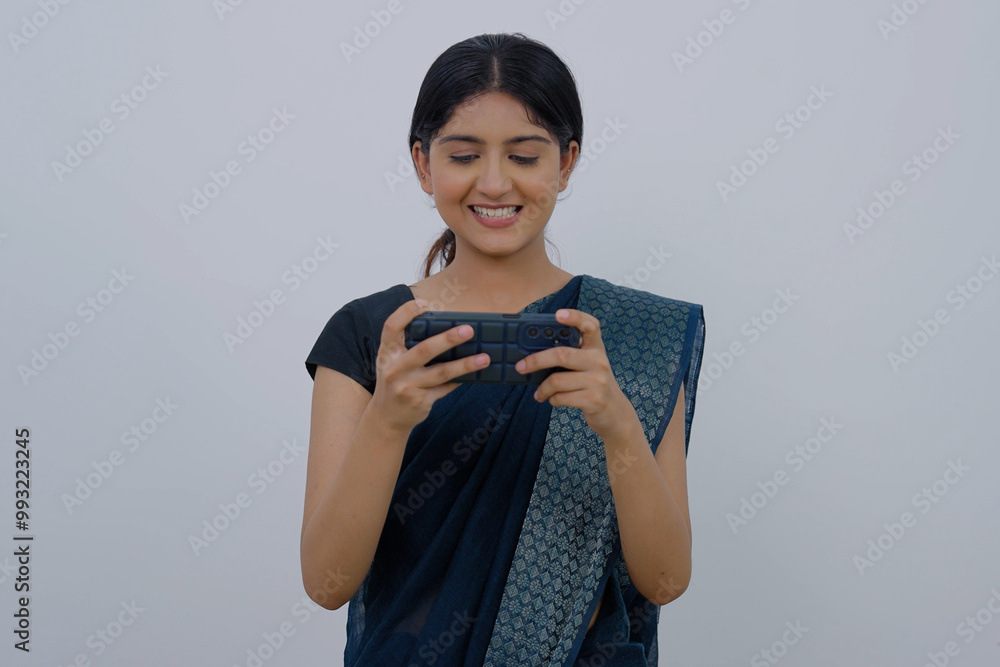 Indian Woman in Saree Playing Game on Phone Indian Woman in Saree Playing Game on Phone