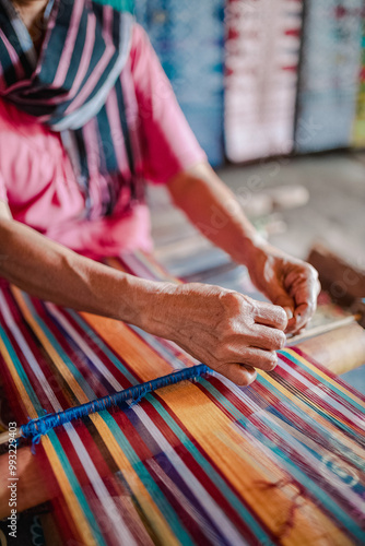 hands of a person weaving a traditional sasak cloth