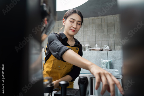 Young Female Barista Preparing Coffee in a Modern Cafe with Industrial Interior Design