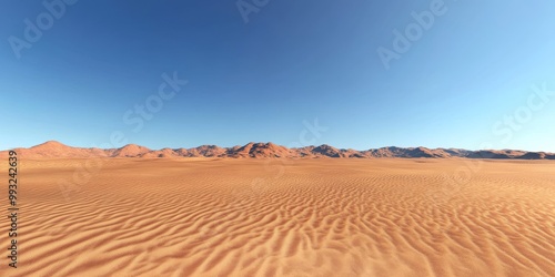 Vast golden desert landscape under a clear blue sky, showcasing rolling dunes and distant mountains.