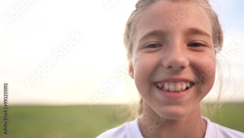 Portrait of a girl and her kid smiling. Little young face concept. Portrait of a young girl and her child outside. Portrait lifestyle of smiling kid and girl playing outdoors.