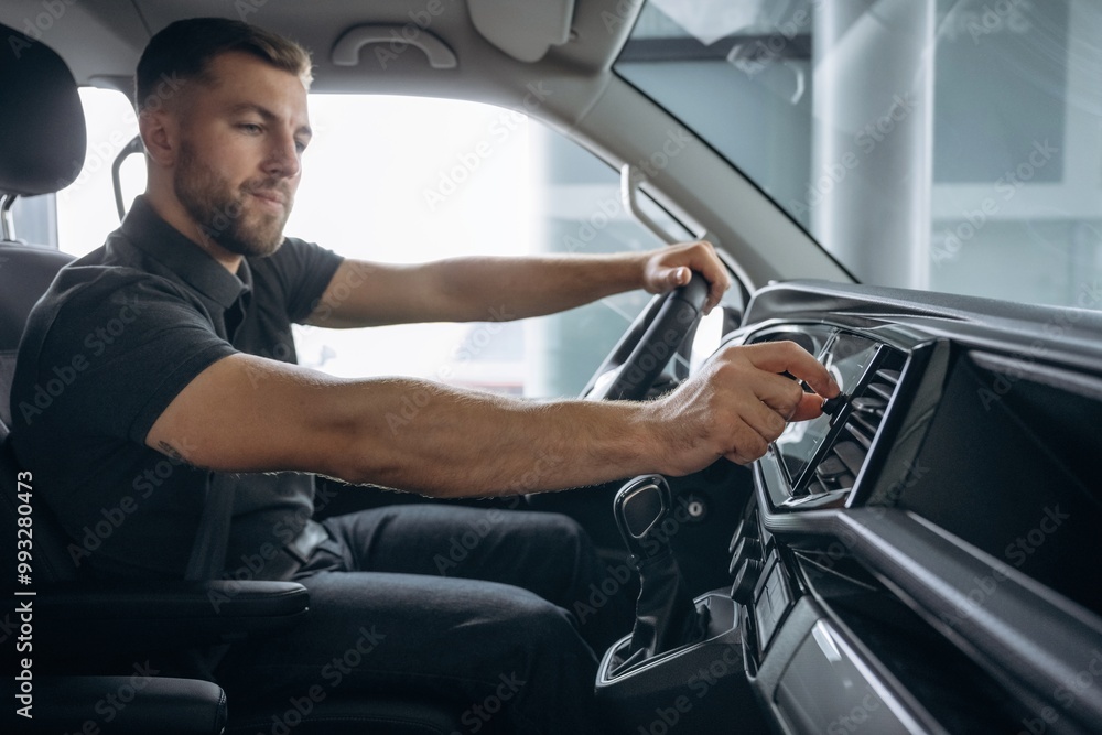 View from the side. Man is sitting in the car, driver View from the side. Man is sitting in the car, driver