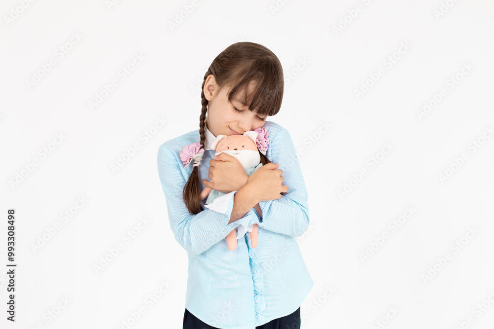 Portrait of satisfied pleasant teen girl wear school uniform embrace fox toy isolated on white background Portrait of satisfied pleasant teen girl wear school uniform embrace fox toy isolated on white background