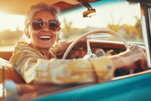 Smiling elderly woman driving a retro car