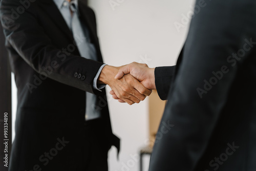 The Deal Closed: A powerful handshake seals a business agreement. Close-up shot emphasizes trust and partnership. Clean and professional. 