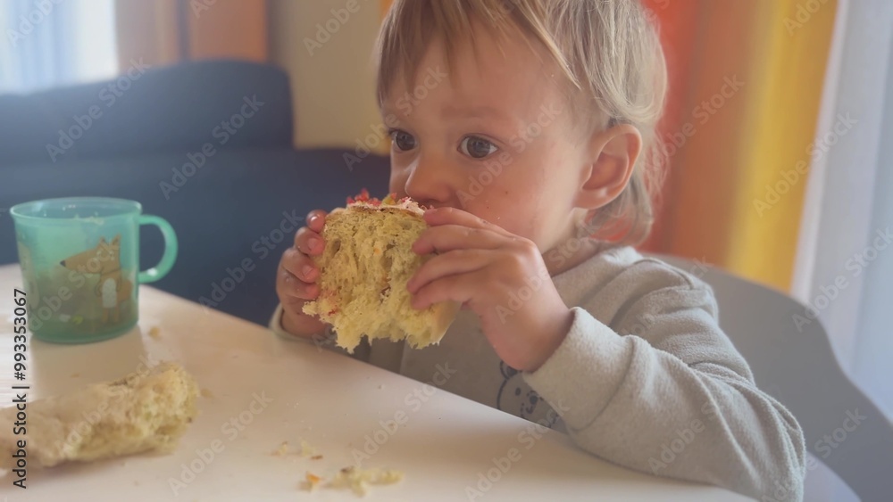 child eats cake. happy family kid dream concept. Baby Toddler eats a delicious cake. little son with blond hair in a colored T-shirt eats a large white cake, close lifestyle up child eats cake. happy family kid dream concept. Baby Toddler eats a delicious cake. little son with blond hair in a colored T-shirt eats a large white cake, close lifestyle up
