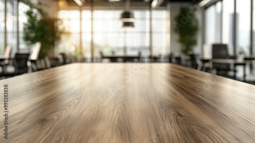 A clean, empty wooden board table in front of a softly blurred modern office room, creating a professional backdrop for work-related content.