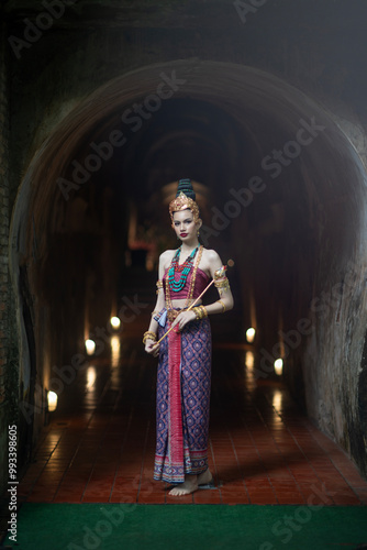 Beautiful young ASEAN woman in traditional Thai Dvaravati dress in an old temple in Chiang Mai, Thailand. photo