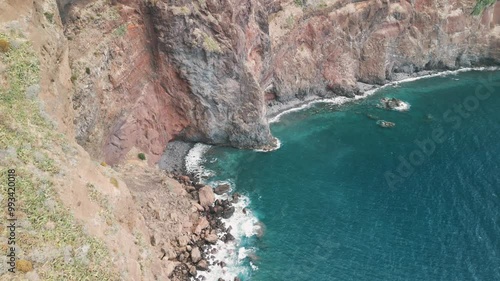 Atlantic waves crashing against the rocky coast of the Portuguese island of Madeira near Christo Rei, Canico. Drone aerial video.