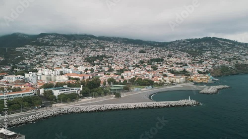 Funchal cityscape, the capital of Madeira island, Portugal. City panorama with the mountains in background. Drone aerial video