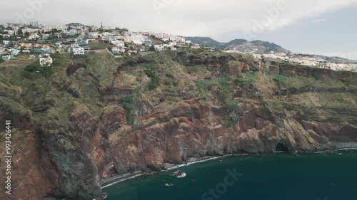 Rocky coastline of the Portuguese island of Madeira near Christo Rei, Canico. Drone aerial video.