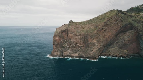 Peninsula with Christo Rei (Christ's Monument) on the Madeira Island near Canico, Portugal. Panorama of the bay. Aerial drone video.