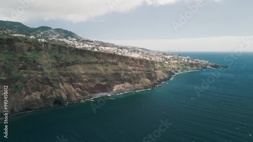 Video panorama of the peninsula with Christo Rei (Christ's Monument), Canico city and Funchal city on the Madeira Island, Portugal. Panorama of the bay. Aerial drone video.