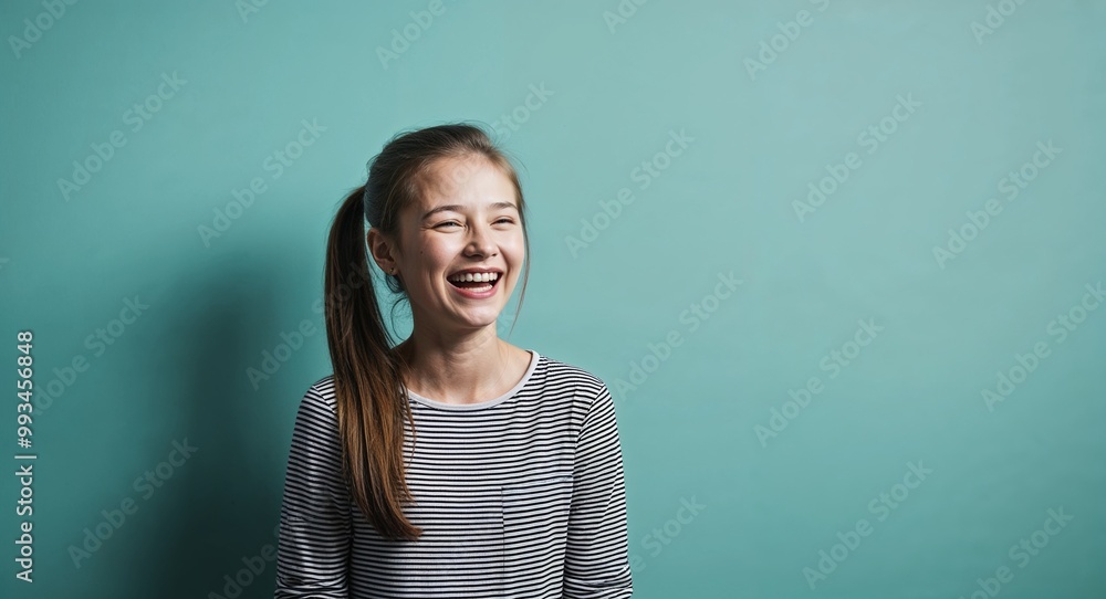 Laughing young Caucasian girl with ponytail wearing sundress on plain purple background Laughing young Caucasian girl with ponytail wearing sundress on plain purple background