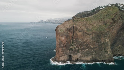 Peninsula with Christo Rei (Christ's Monument) on the Madeira Island near Canico, Portugal. Panorama of the bay. Aerial drone video.