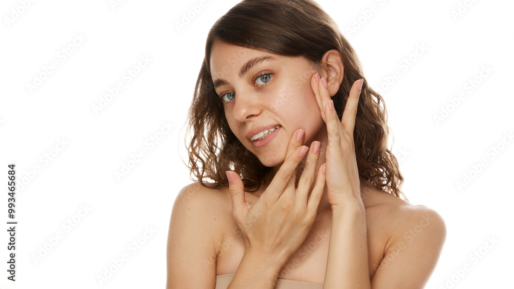 Woman gently touching her face, highlighting skincare and self-care routine against white studio background. Concept of natural beauty, fashion, appearance, self care, cosmetology treatment. Ad Woman gently touching her face, highlighting skincare and self-care routine against white studio background. Concept of natural beauty, fashion, appearance, self care, cosmetology treatment. Ad