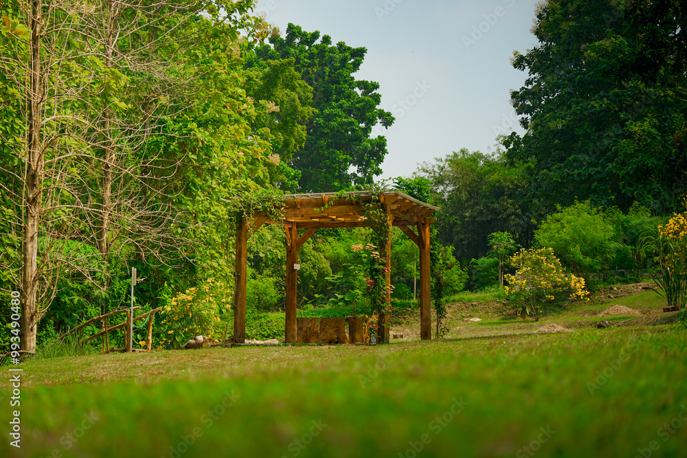 Jakarta, 26 September 2024: Outdoor seating area. Gazebos, pergolas in the garden and garden - relax and unwind. Wooden gazebo in the garden. Jakarta, 26 September 2024: Outdoor seating area. Gazebos, pergolas in the garden and garden - relax and unwind. Wooden gazebo in the garden.