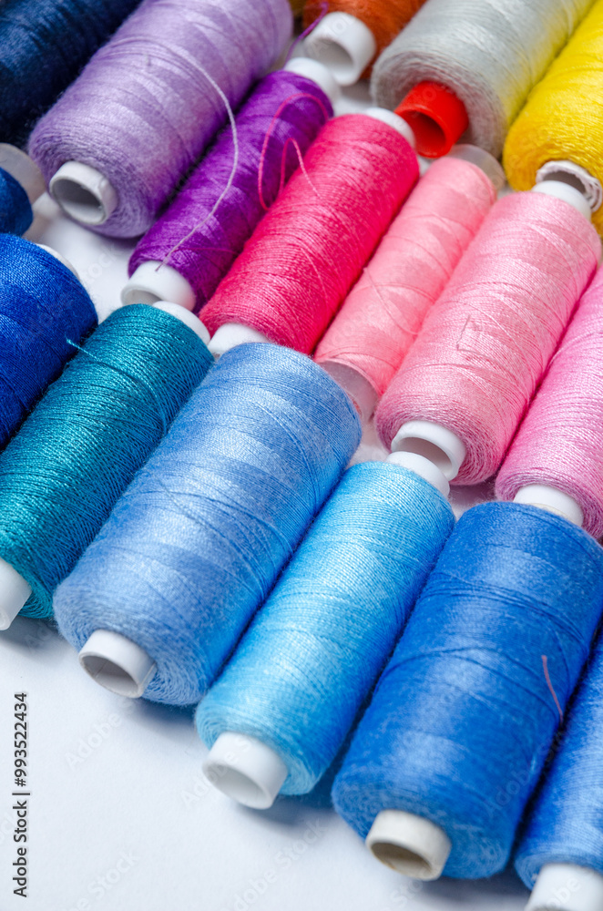 Top view of many colorful thread spools background Top view of many colorful thread spools background