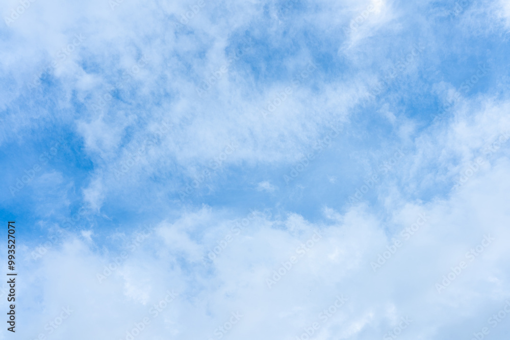 Fluffy white clouds drift across a vibrant blue sky, creating a breathtaking natural canvas Fluffy white clouds drift across a vibrant blue sky, creating a breathtaking natural canvas