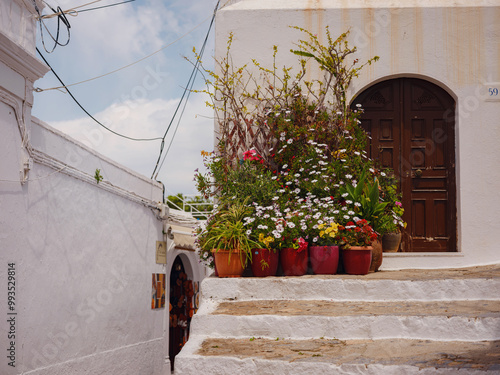 Fototapeta Naklejka Na Ścianę i Meble -  travel to city of Lindos on island of Rhodes, Greece. Details of streets of old town Lindos. Interesting elements of door, shutters, bas-relief of walls. tourist attraction on island of Rhodes