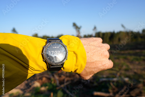 Smartwatch travel. Hiker checking map on sports watch. Expedition martwatch. Watch for wild survival. Outdoor, hiking Watch on hand. GPS track in Smartwatch. Traveler with watch on hand in adventure. photo