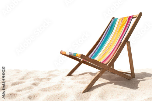 A colorful beach chair on a sandy shore under a bright sky photo