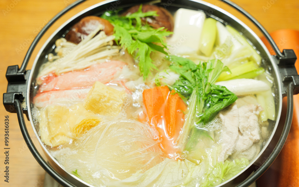 Traditional Japanese one-pot dish, consisting of carrots and other vegetables, mushrooms, meat, fish or crab, etc., simmered in a pot. Traditional Japanese one-pot dish, consisting of carrots and other vegetables, mushrooms, meat, fish or crab, etc., simmered in a pot.