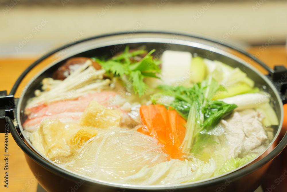 Traditional Japanese one-pot dish, consisting of carrots and other vegetables, mushrooms, meat, fish or crab, etc., simmered in a pot. Traditional Japanese one-pot dish, consisting of carrots and other vegetables, mushrooms, meat, fish or crab, etc., simmered in a pot.