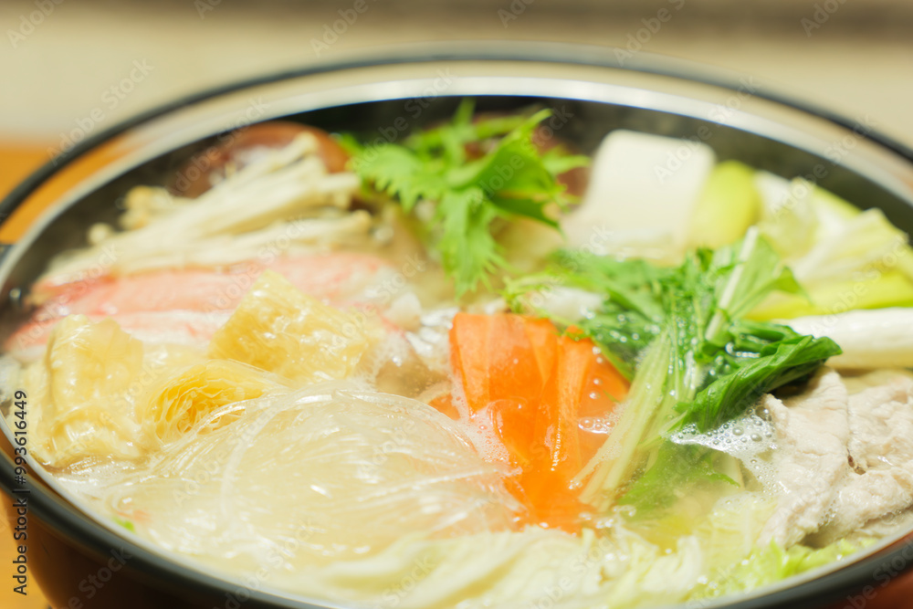 Traditional Japanese one-pot dish, consisting of carrots and other vegetables, mushrooms, meat, fish or crab, etc., simmered in a pot. Traditional Japanese one-pot dish, consisting of carrots and other vegetables, mushrooms, meat, fish or crab, etc., simmered in a pot.