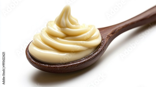 Spoon of mayonnaise isolated on a white background