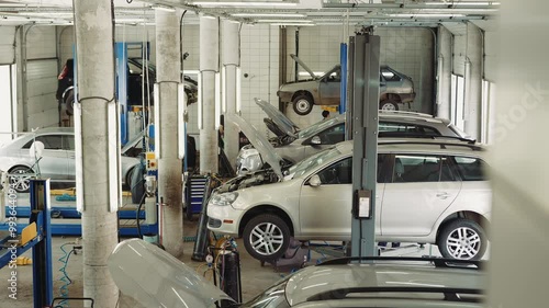 Professional Car Service Station with Vehicles on Lifts And Auto Maintenance and Repair in Action photo