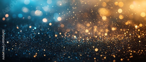 A shimmering blend of blue and gold bokeh lights creating a festive, atmospheric background.