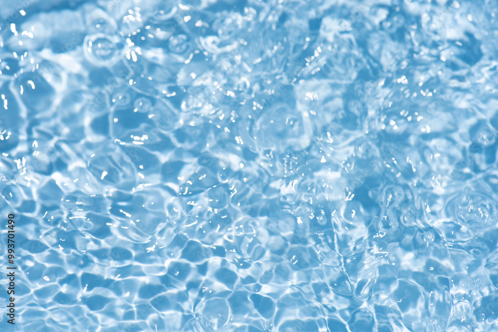 Blue water with ripples on the surface. Defocus blurred transparent blue colored clear calm water surface texture with splashes and bubbles. Water waves with shining pattern texture background. Blue water with ripples on the surface. Defocus blurred transparent blue colored clear calm water surface texture with splashes and bubbles. Water waves with shining pattern texture background.