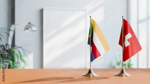 FLAGS OF COMOROS AND SWITZERLAND ON TABLE