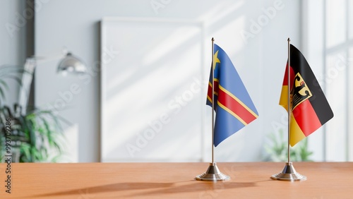 FLAGS OF CONGO DEMOCRATIC REPUBLIC AND GERMANY ON TABLE photo