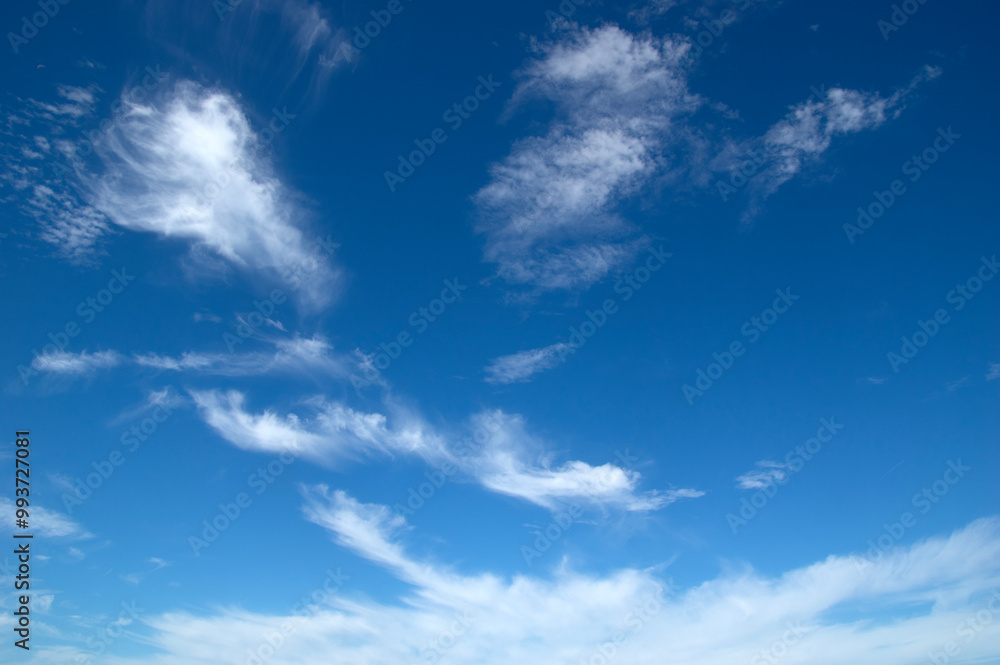White fluffy clouds in the blue sky. White fluffy clouds in the blue sky.